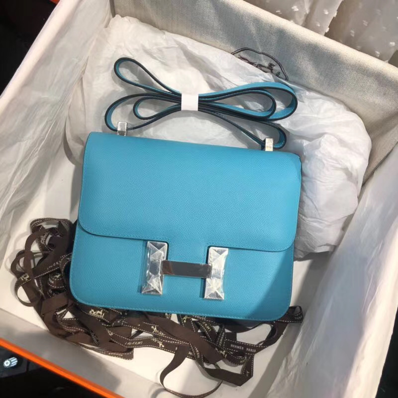 Hermes Blue Atoll Epsom Constance 24cm Color: Blue Size: 24cm x 15cm x 5 cm Hardware: Silver Buckle Leather: Epsom calf Leather Pockets: zip pocket with a Hermes engraved pull Accompanied by: Hermes box, Hermes dustbag, ribbon, and care book